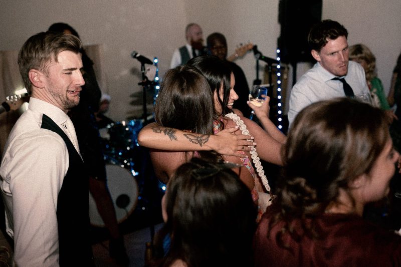 Guests enjoying a lively dance at a wedding reception.