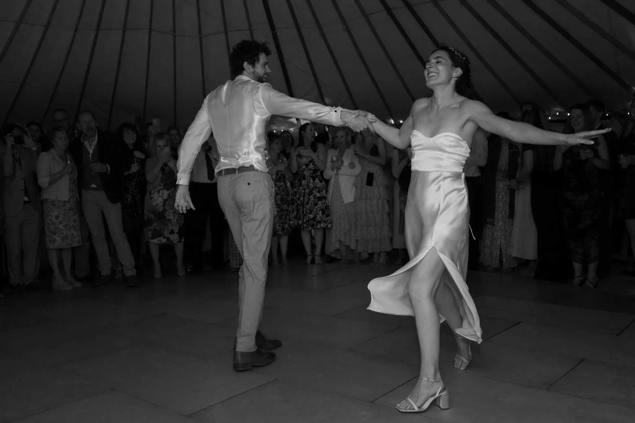 A black and white photograph capturing a wedding ceremony.