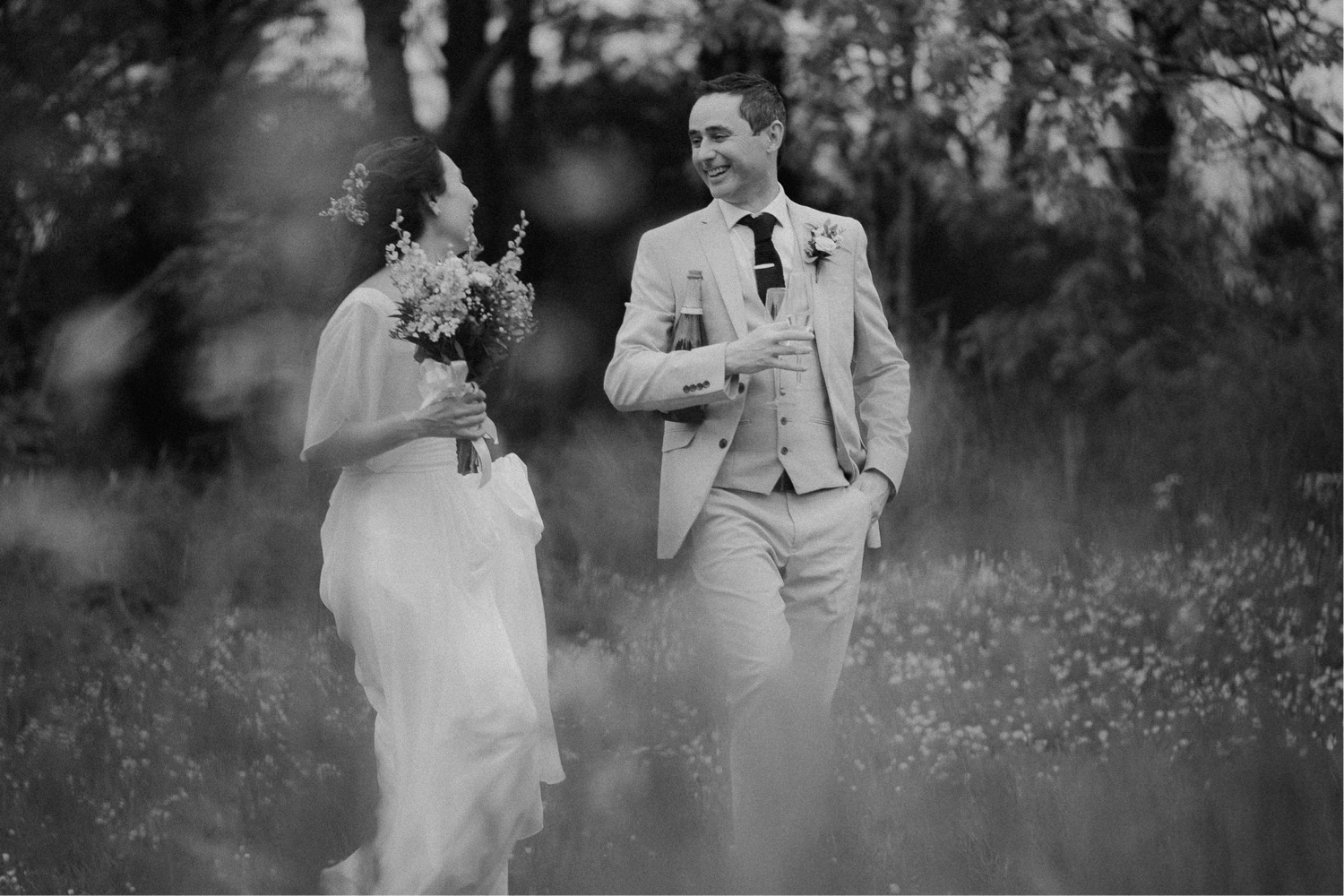 Wedding couple photographed in a field.